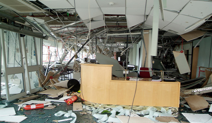 Destruction of commercial office interior with collapsed ceiling