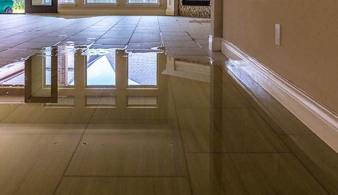 Flooded tile floor with standing water