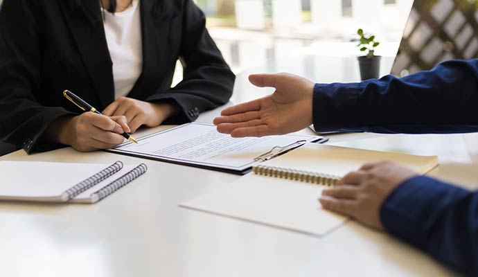 Insurance adjuster explaining claim policy documents to client