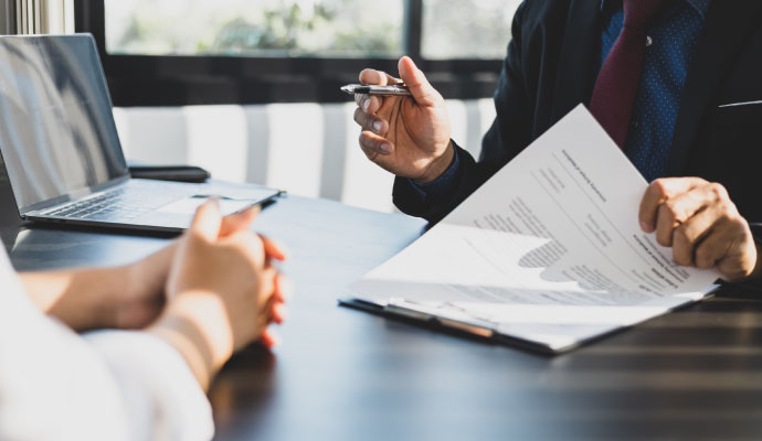 Insurance adjuster reviewing claim paperwork with client