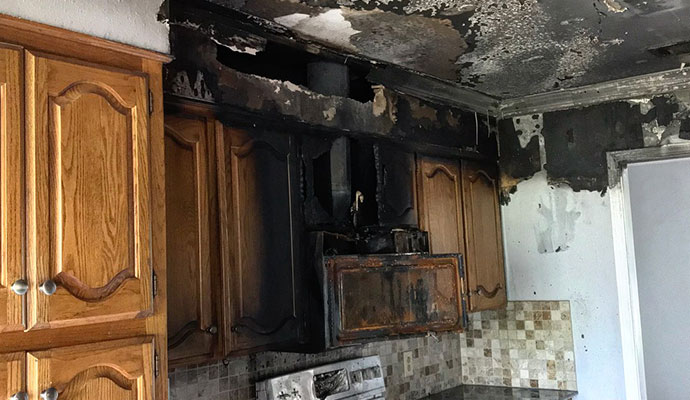 Kitchen cabinets and ceiling charred by fire