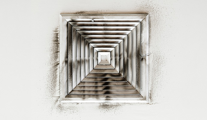 Smoke and soot residue on ceiling air vent grille