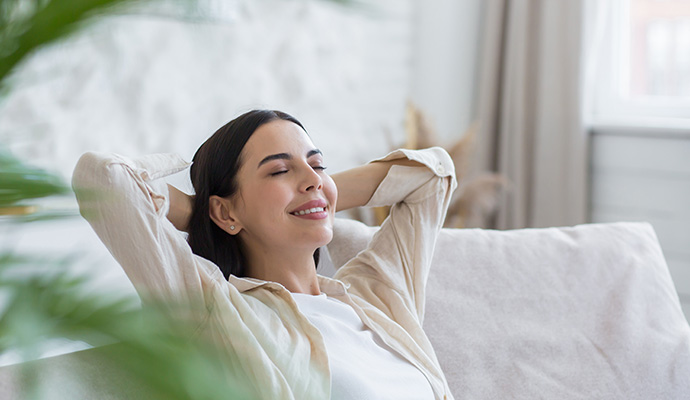 Woman relaxing on sofa enjoying clean indoor air