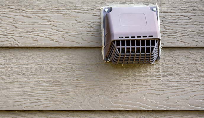 Dryer vent on the wooden wall