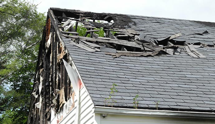 Fire damaged house roof and siding