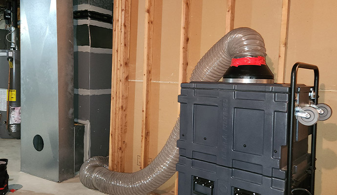 HEPA air scrubber connected to HVAC duct