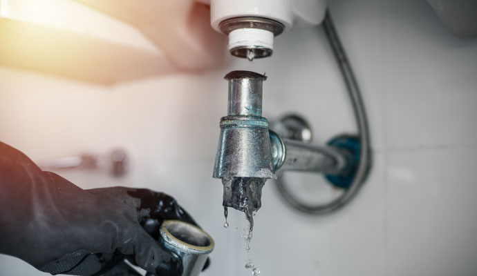 Professional plumber cleaning a clogged drain 