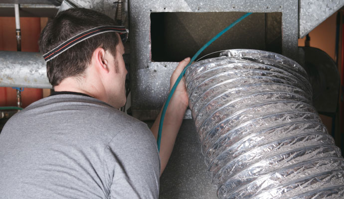 Technician working on hvac air duct system