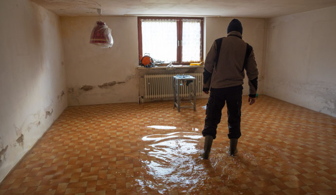 A technician standing in a flooded basement