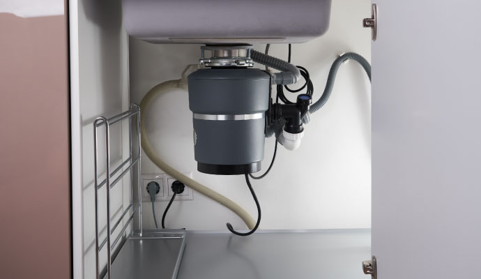 Garbage disposal unit installed under kitchen sink