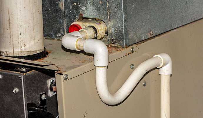 PVC condensate drain pipe connected to AC air handler unit